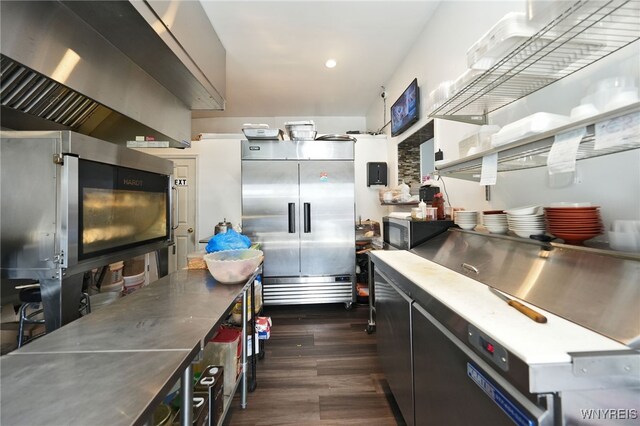 894 Tonawanda St, Buffalo, NY 14207 - kitchen with dark wood-type flooring, wall chimney range hood, stainless steel countertops, and stainless steel appliances