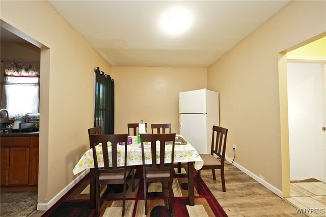 894 Tonawanda St, Buffalo, NY 14207 - dining area with baseboards and light wood-style floors