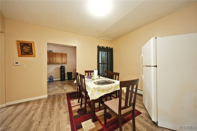 894 Tonawanda St, Buffalo, NY 14207 - dining space featuring a baseboard radiator, wood finished floors, and baseboards