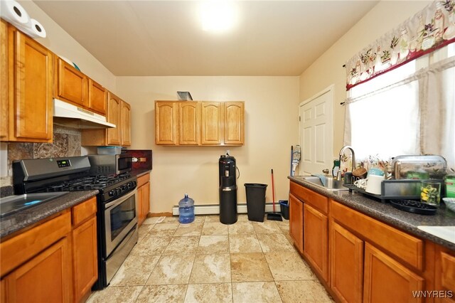 894 Tonawanda St, Buffalo, NY 14207 - kitchen with tasteful backsplash, a sink, dark countertops, under cabinet range hood, and stainless steel appliances