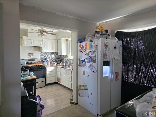 1358 Hudson Ave, Rochester, NY 14621 - kitchen featuring a sink, white refrigerator with ice dispenser, white cabinetry, and gas stove