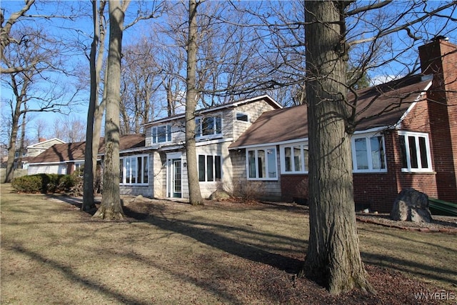 6634 Lake Shore Rd, Evans, NY 14047 - view of front of property with a chimney, a front yard, and brick siding