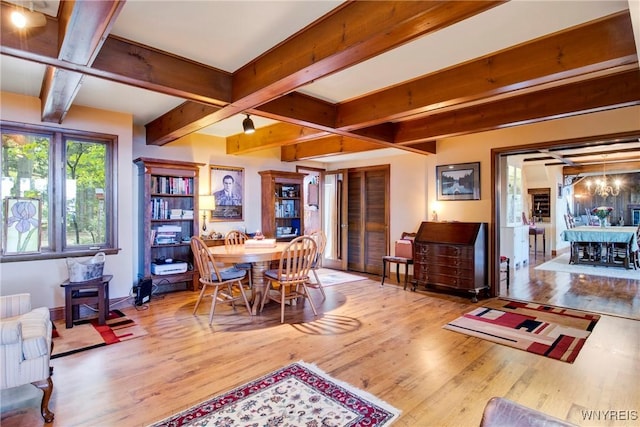 6634 Lake Shore Rd, Evans, NY 14047 - dining room featuring a wood stove, wood finished floors, and beamed ceiling