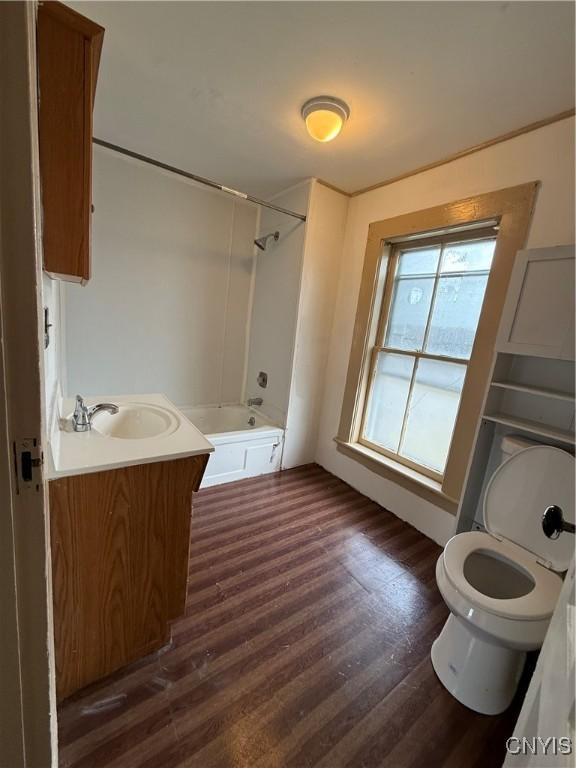 620 Court St, Syracuse, NY 13208 - bathroom featuring toilet, shower / bath combination, wood finished floors, and vanity