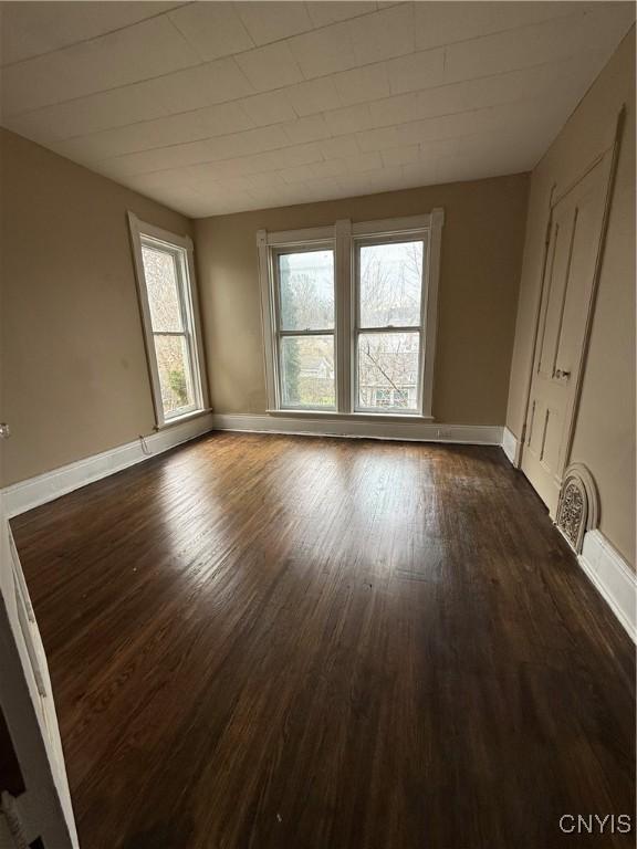 620 Court St, Syracuse, NY 13208 - unfurnished room with dark wood-type flooring and baseboards
