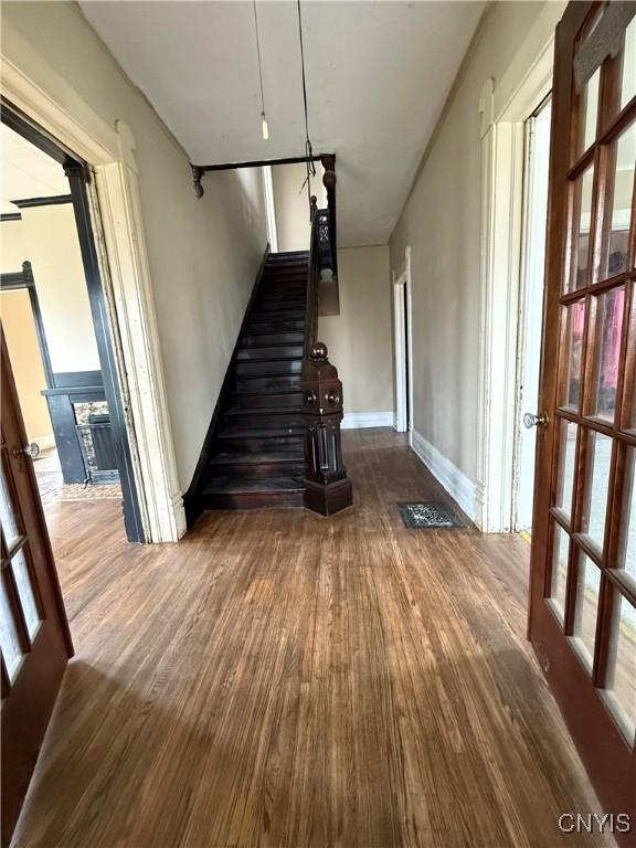 620 Court St, Syracuse, NY 13208 - stairs with visible vents, baseboards, and wood finished floors