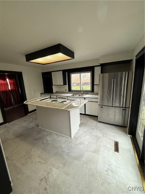 620 Court St, Syracuse, NY 13208 - kitchen featuring visible vents, light countertops, freestanding refrigerator, and a center island