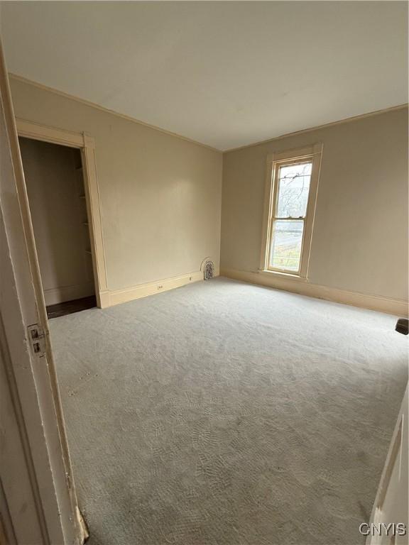 620 Court St, Syracuse, NY 13208 - carpeted empty room with baseboards