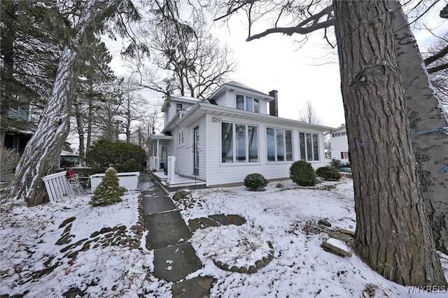 8784 Lake Shore Rd, Evans, NY 14006 - view of snowy exterior with a chimney