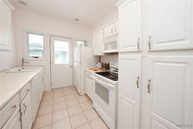 8784 Lake Shore Rd, Evans, NY 14006 - kitchen featuring white appliances, a sink, white cabinets, light tile patterned floors, and light countertops