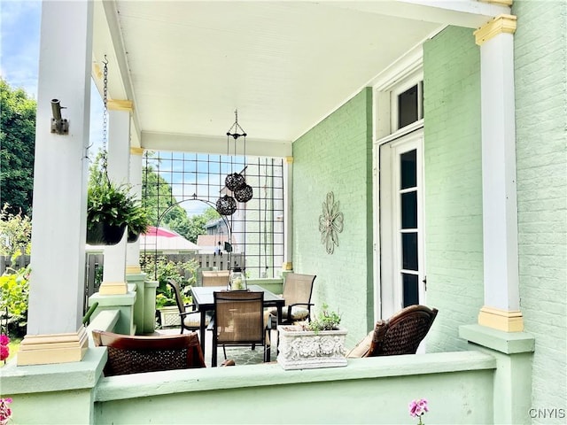 exterior space featuring a porch and outdoor dining area