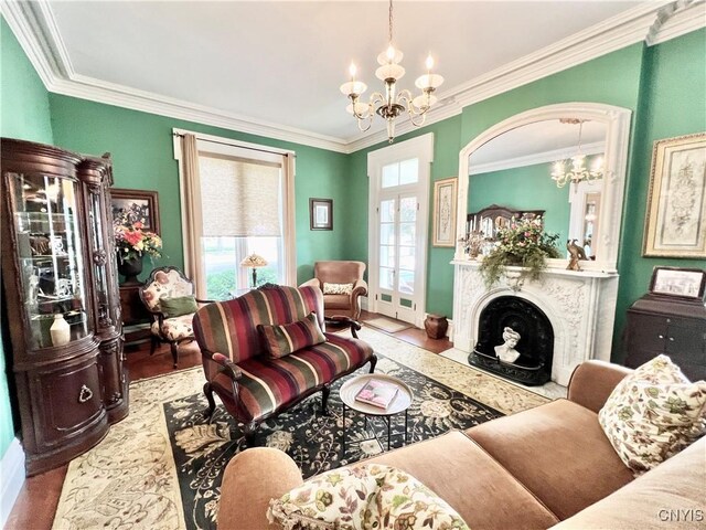 living room featuring ornamental molding, a notable chandelier, and a fireplace