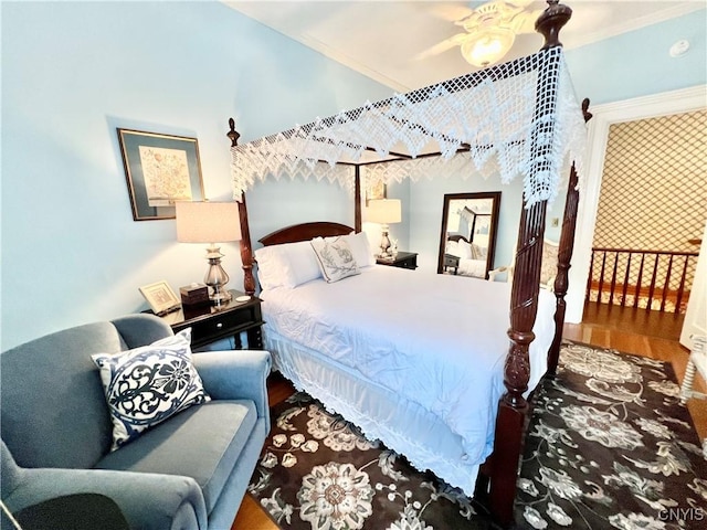 bedroom featuring ornamental molding, ceiling fan, and wood finished floors