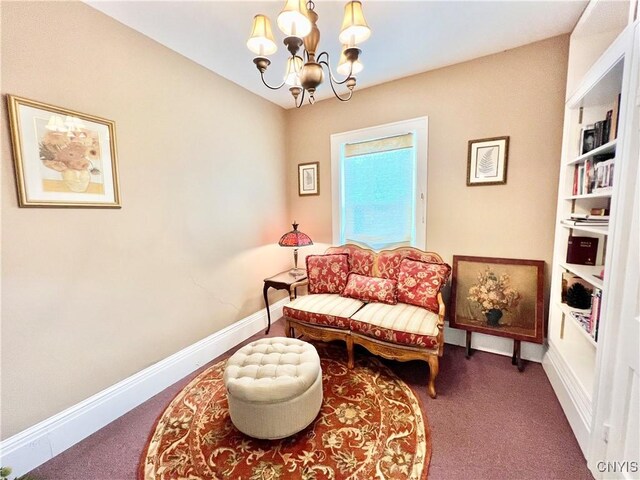 sitting room featuring a chandelier, carpet flooring, and baseboards