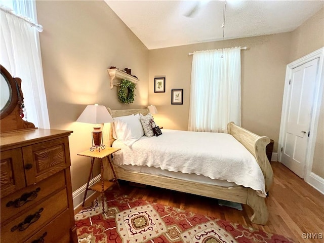 bedroom featuring wood finished floors and baseboards
