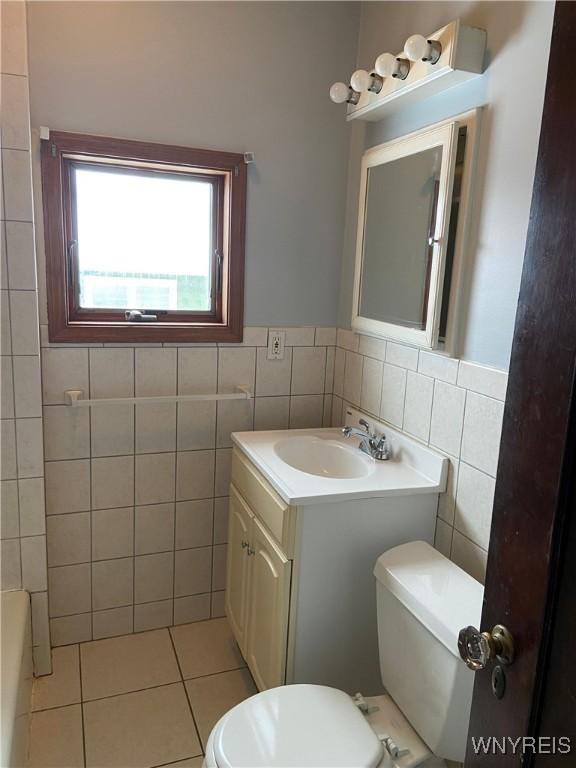 333 Colvin Ave, Buffalo, NY 14216 - full bath with vanity, tile patterned flooring, a wainscoted wall, toilet, and tile walls