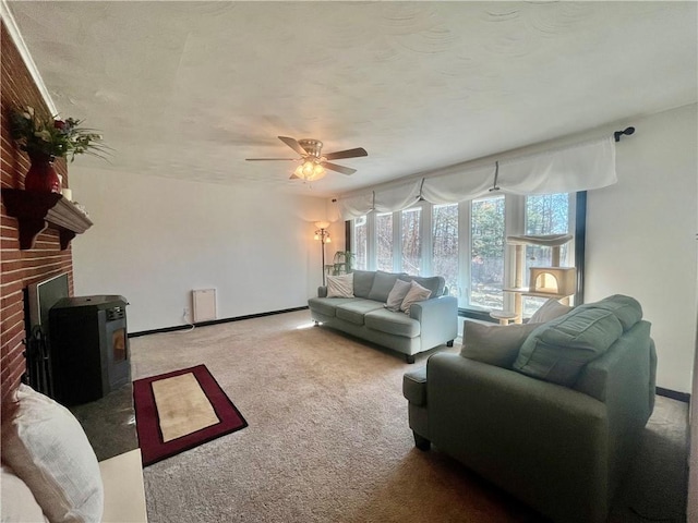 115 Forest Hills Dr, Elmira, NY 14905 - carpeted living area with a ceiling fan, a wood stove, and baseboards