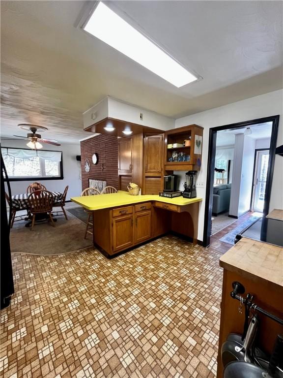 115 Forest Hills Dr, Elmira, NY 14905 - kitchen with butcher block countertops, brown cabinetry, ceiling fan, a peninsula, and open shelves