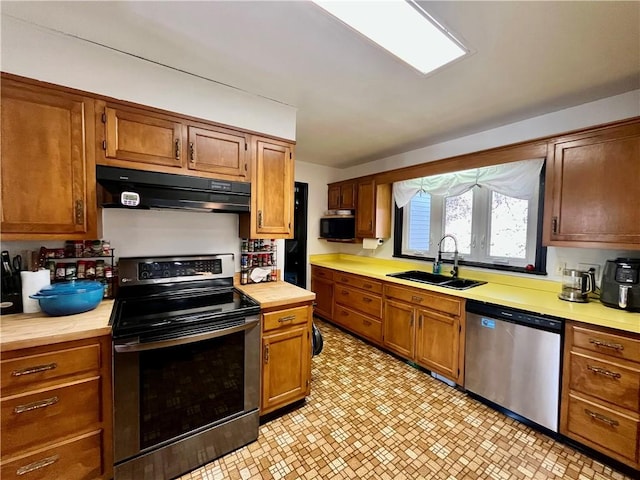 115 Forest Hills Dr, Elmira, NY 14905 - kitchen featuring a sink, stainless steel appliances, light floors, under cabinet range hood, and wooden counters