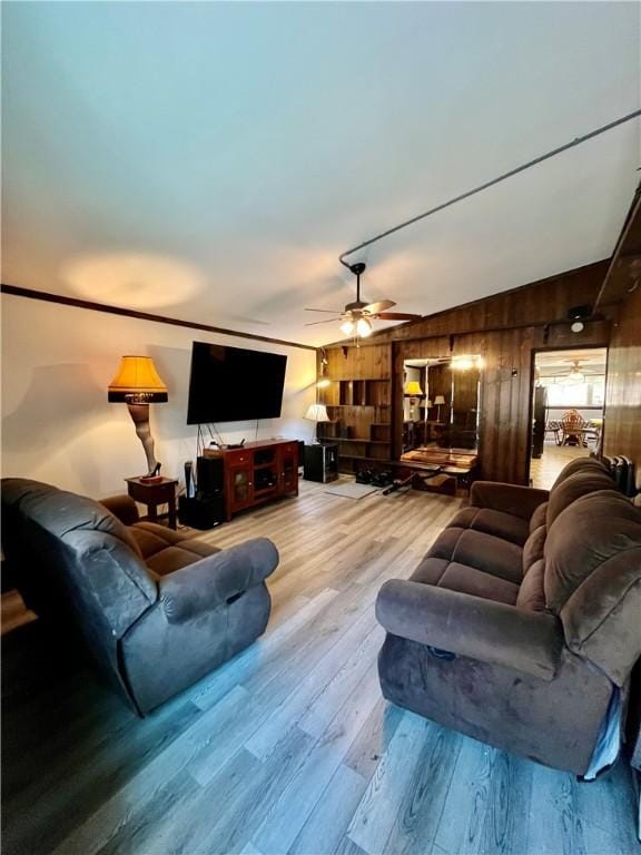 115 Forest Hills Dr, Elmira, NY 14905 - living room with wood walls, ceiling fan, and wood finished floors