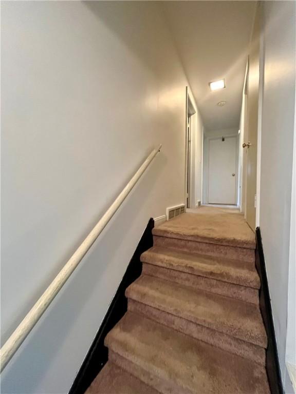115 Forest Hills Dr, Elmira, NY 14905 - stairway with baseboards, visible vents, and carpet