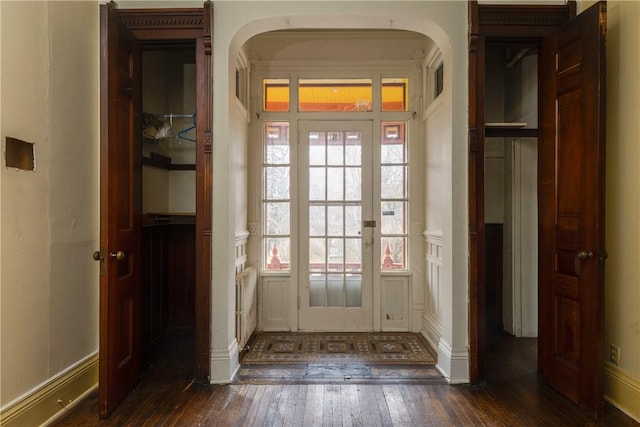 24 W 2nd St, Corning-City, NY 14830 - doorway with arched walkways, a decorative wall, wainscoting, and hardwood / wood-style floors