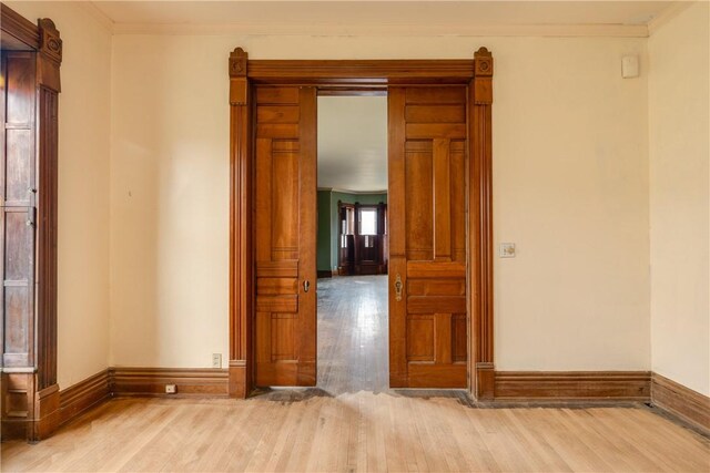 24 W 2nd St, Corning-City, NY 14830 - empty room with crown molding, baseboards, and light wood finished floors