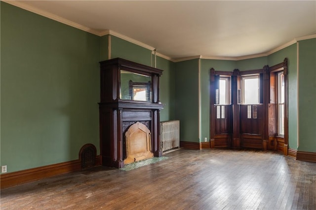 24 W 2nd St, Corning-City, NY 14830 - unfurnished living room featuring baseboards, ornamental molding, a fireplace with flush hearth, wood-type flooring, and radiator heating unit