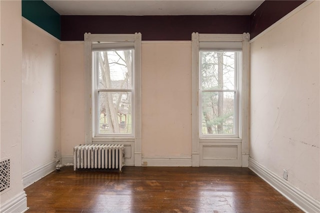 24 W 2nd St, Corning-City, NY 14830 - unfurnished room featuring radiator, baseboards, and hardwood / wood-style flooring