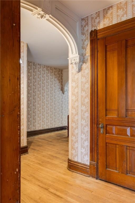 24 W 2nd St, Corning-City, NY 14830 - corridor with wood finished floors, baseboards, and wallpapered walls