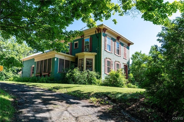 view of property exterior featuring a lawn