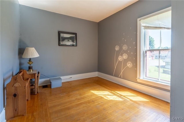 empty room with light wood-type flooring and baseboards