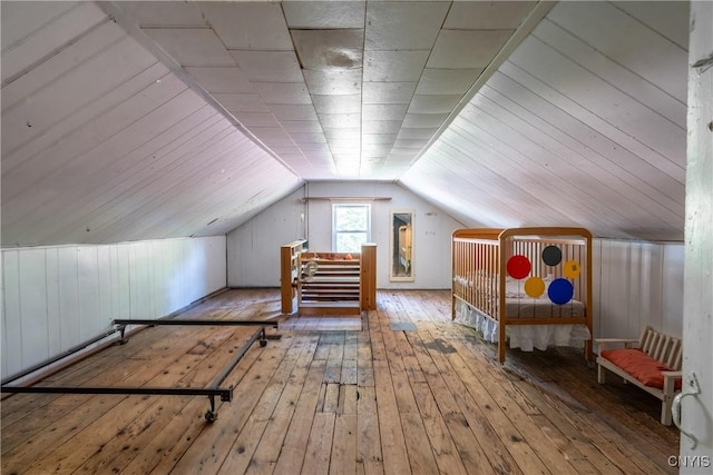 bonus room featuring wood-type flooring and vaulted ceiling