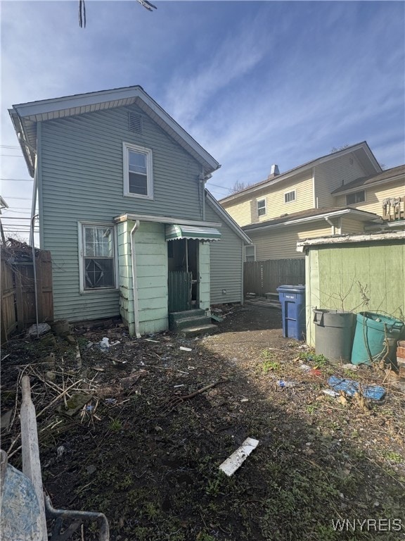 back of property featuring fence