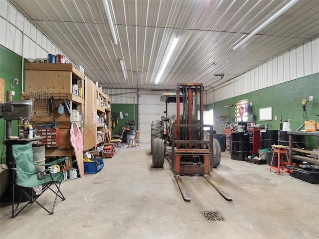 garage featuring metal wall and a workshop area