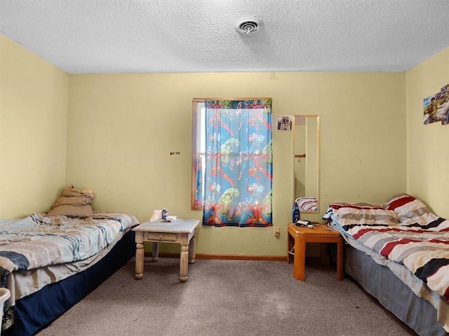 carpeted bedroom with visible vents, a textured ceiling, and baseboards