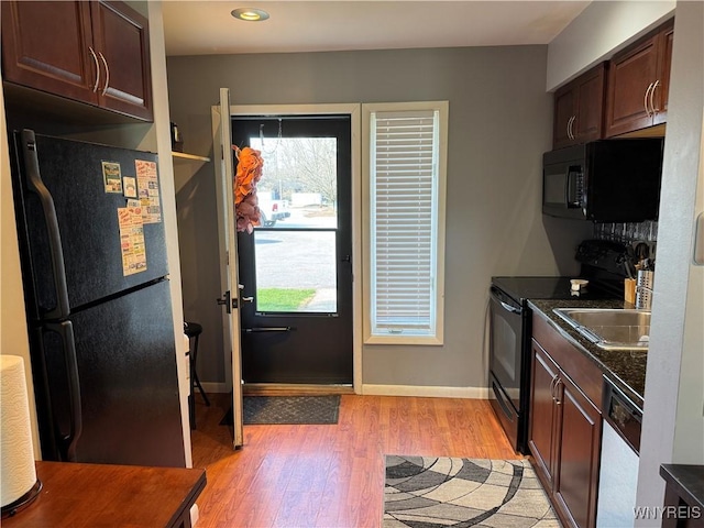 13 Wildflower, Ellicottville, NY 14731 - kitchen featuring baseboards, dark countertops, light wood-style floors, dark brown cabinets, and black appliances