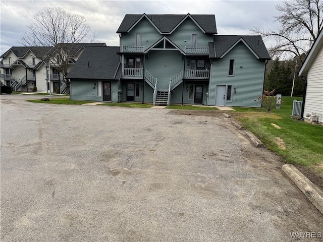 13 Wildflower, Ellicottville, NY 14731 - view of front of property with a residential view, a front yard, stairs, and a balcony