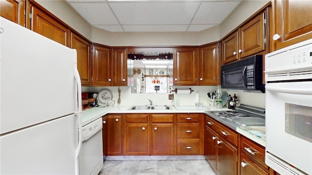 5 E Washington St, Bath, NY 14810 - kitchen featuring white appliances, brown cabinetry, a drop ceiling, light countertops, and a sink