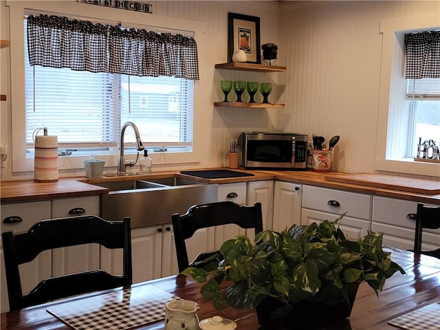 204 Ives Settlement Rd, Guilford, NY 13780 - kitchen with stainless steel microwave, a wealth of natural light, wood counters, and white cabinets