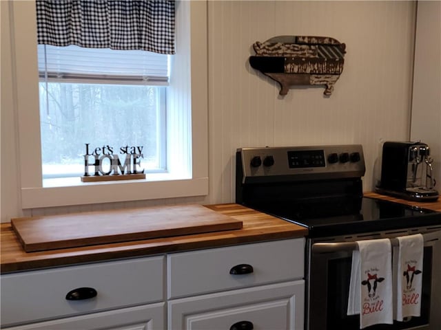 204 Ives Settlement Rd, Guilford, NY 13780 - kitchen with wood counters, stainless steel range with electric cooktop, and white cabinetry