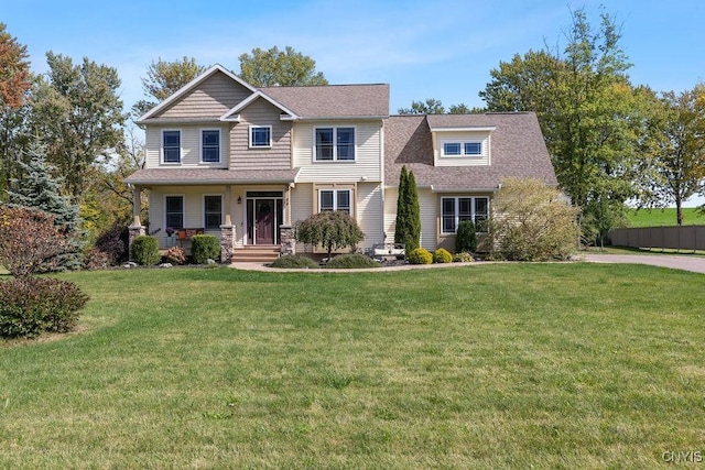 view of front of house with a front yard and roof with shingles