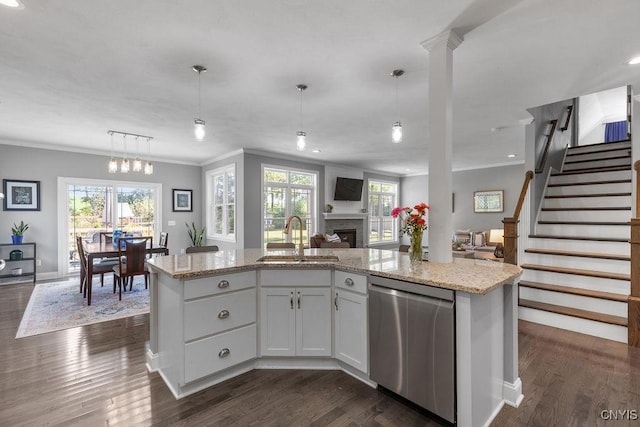 kitchen featuring ornamental molding, open floor plan, dark wood-type flooring, stainless steel dishwasher, and a sink