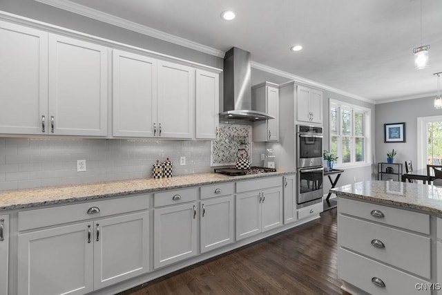 kitchen with tasteful backsplash, ornamental molding, wall chimney range hood, dark wood-type flooring, and stainless steel appliances