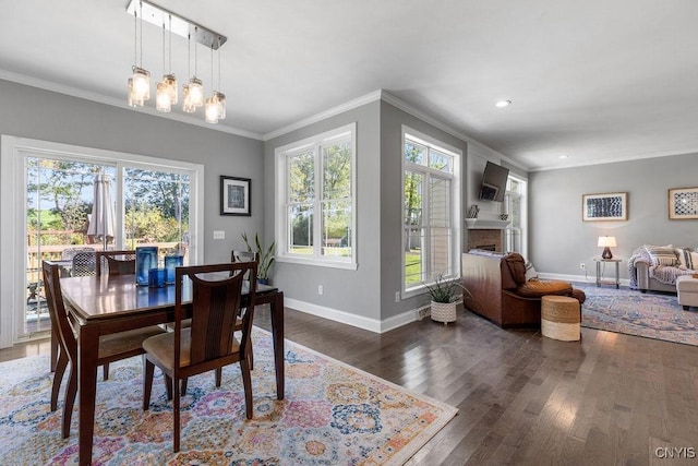 dining room featuring baseboards, ornamental molding, a fireplace, recessed lighting, and wood finished floors