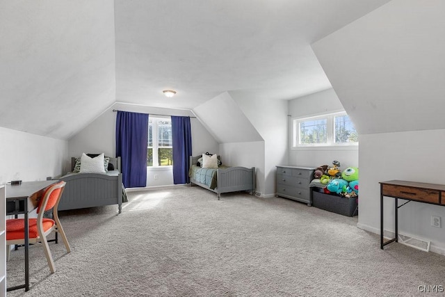 carpeted bedroom featuring baseboards, multiple windows, and lofted ceiling