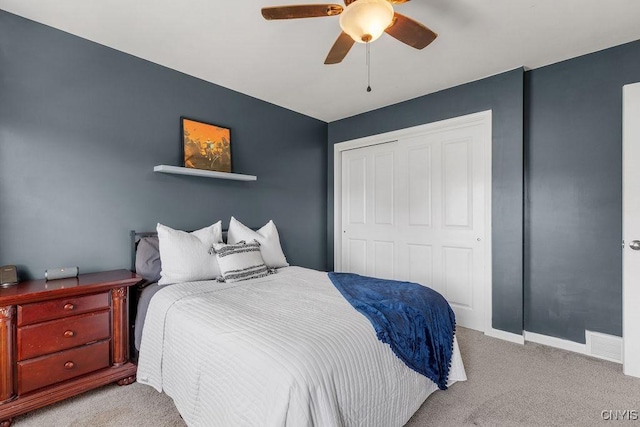 bedroom featuring ceiling fan, a closet, visible vents, carpet floors, and baseboards