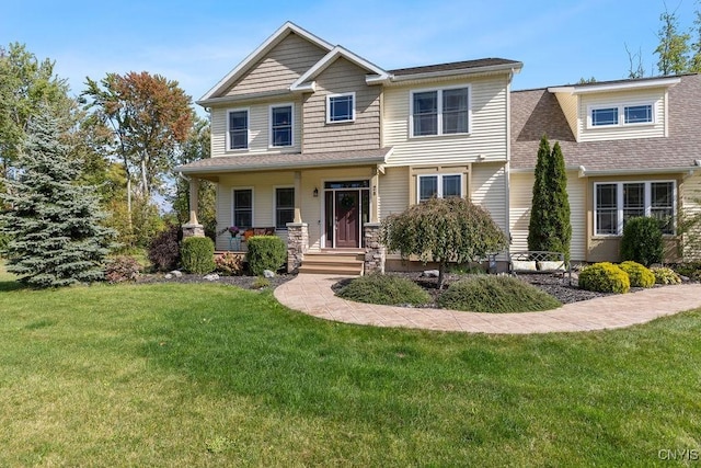 craftsman inspired home featuring a porch and a front lawn