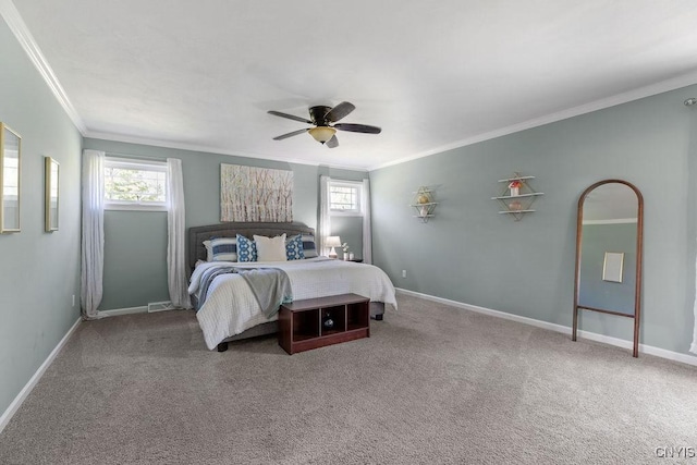 carpeted bedroom with ornamental molding, baseboards, and ceiling fan