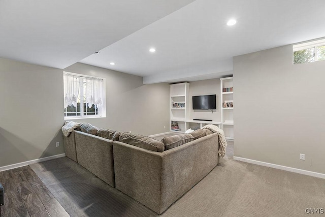 living area featuring baseboards and recessed lighting